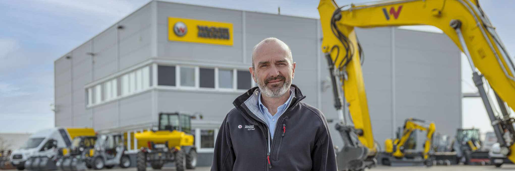 Wacker Neuson employee standing in front of Wacker Neuson rental station.