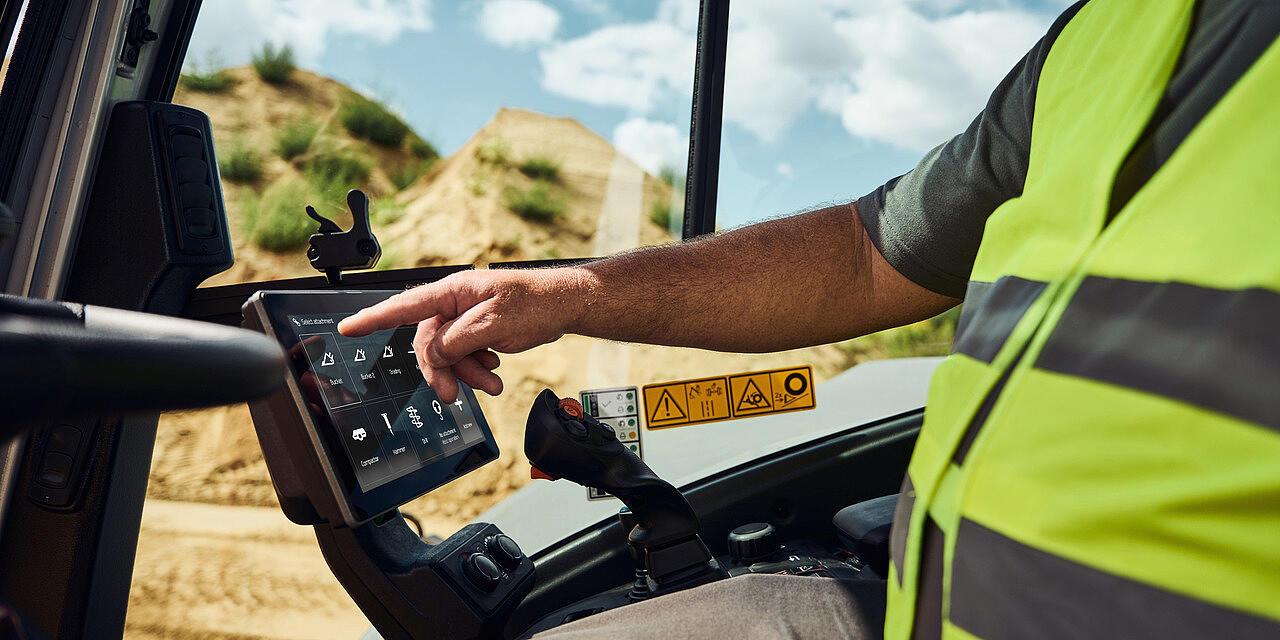 man using display in excavator